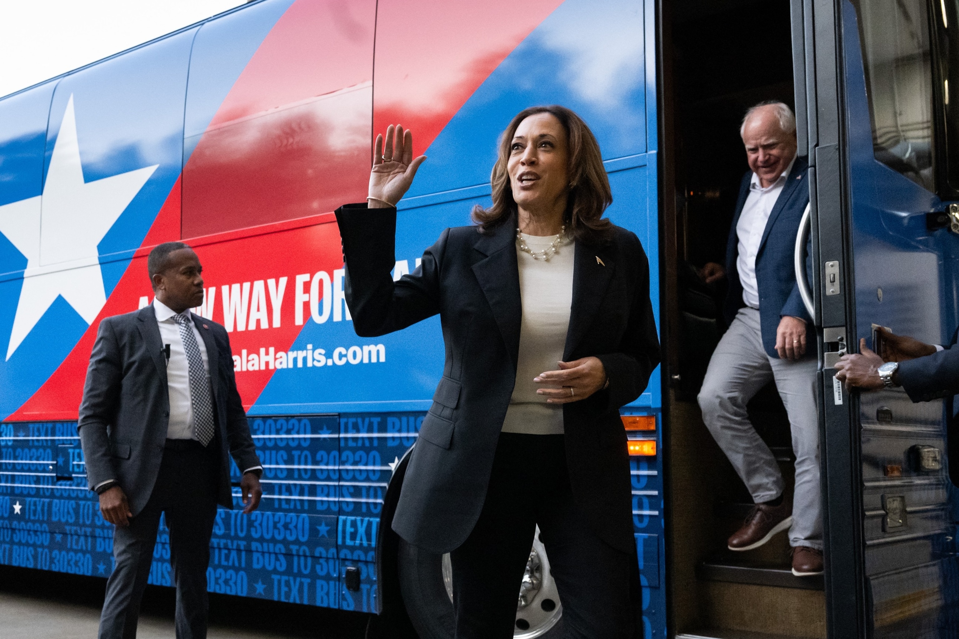 PHOTO: Democratic presidential candidate US Vice President Kamala Harris and Minnesota Governor Tim Walz, disembark from their campaign bus in Savannah, Georgia, Aug. 28, 2024, as they travel across Georgia for a 2-day campaign bus tour. 